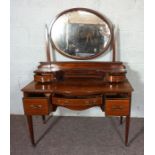 An Edwardian mahogany and line inlaid dressing table, with a matching bedside cabinet, circa 1910,