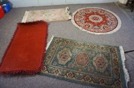 Four small decorative rugs, modern, including a circular rug with red brown ground (4)