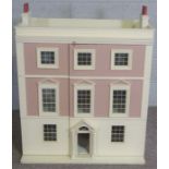 A vintage child’s Doll House, styled as a Georgian three story mansion, the front opening to