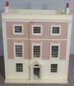 A vintage child’s Doll House, styled as a Georgian three story mansion, the front opening to