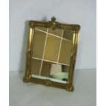 A gilt brass framed table top mirror, circa 1900, with moulded frame and coronet surmount, fitted