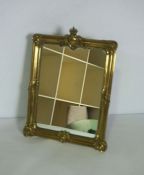 A gilt brass framed table top mirror, circa 1900, with moulded frame and coronet surmount, fitted