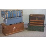 Five vintage trunks, including a slatted dome topped example, a stained pine blanket box, two