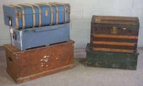 Five vintage trunks, including a slatted dome topped example, a stained pine blanket box, two