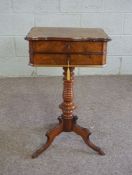 A Victorian walnut work table, circa 1870, with a hinged moulded top, opening to reveal a fitted