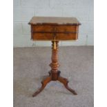 A Victorian walnut work table, circa 1870, with a hinged moulded top, opening to reveal a fitted