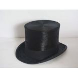 A black silk top hat, by D.M. Dunlop, with cardboard caseCondition reportHat is in generally