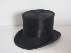 A black silk top hat, by D.M. Dunlop, with cardboard caseCondition reportHat is in generally