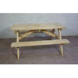 A modern pine picnic table, with bench seats, 73cm high 150cm long, made by Kaimburn of Jedburgh