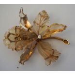 A diamond and carved quartz set orchid brooch, 20th century, with a single seed diamond centred in a