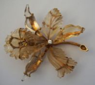 A diamond and carved quartz set orchid brooch, 20th century, with a single seed diamond centred in a