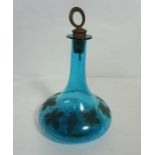 A George III light blue glass ships decanter, engraved with fruit of the vine and set with a brass