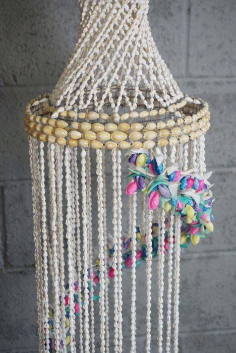 A pair of large decorative hanging shell mobiles, each with a spiral of coloured shells, 133cm &