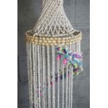 A pair of large decorative hanging shell mobiles, each with a spiral of coloured shells, 133cm &