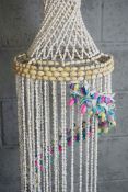 A pair of large decorative hanging shell mobiles, each with a spiral of coloured shells, 133cm &