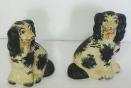 A large assortment of ceramic and glass ornaments, including a pair of Staffordshire Spaniels, three