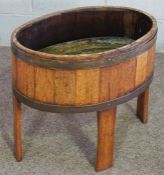 A three tier cake stand with brass supports, together with an oak and brass coopered jardiniere