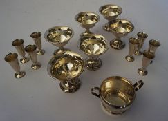 A set of eight German silver bon bon dishes, 8cm high; together with eight small white metal trumpet