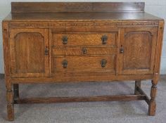 An Edwardian oak sideboard, with two cupboards, and three drawers