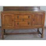 An Edwardian oak sideboard, with two cupboards, and three drawers