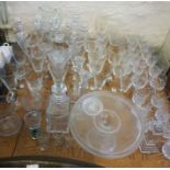 A large assortment of table glassware, including a set of six craque glass goblets, a glass cakes