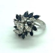 A sapphire and diamond tiered cluster engagement ring, platinum setting, ring size M, set with 13
