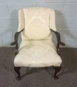 A George II style armchair, 20th century, upholstered in cream, with cabriole legs