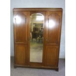 A modern mahogany veneered triple wardrobe, 20th century, with mirrored door, 202cm high, 153cm