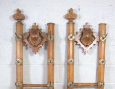A pair of Victorian oak gothic revival hall stands, with a central vacant shield, eight brass coat