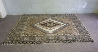 A large modern wool rug, with central lozenge on light cream and brown ground, 250cm x 175cm;