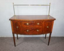 A late Regency mahogany bowfront sideboard, early 19th century, of compact form, with a brass