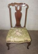 A compact George I style walnut armchair and matching side chair, both with shaped vase splats and