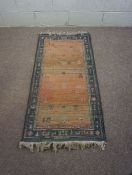 Three small rugs, all modern, including a small rug with stylisting animals on a red ground within a