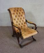 A Regency style mahogany and leather Library bergere armchair, ,with a scrolled back, leather button