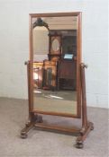 A Victorian mahogany cheval mirror, circa 1870, the rectangular plate on swing mount and set on