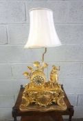 A French style gilt metal table clock and lamp stand, in Louis XV style, circa 1960, 55cm high (to