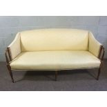 A George III style mahogany canapé (or settee), 20th century, currently upholstered in yellow