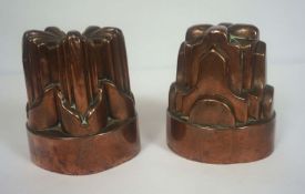 Two 19th century copper jelly moulds, one of lobed form and stamped '10', 14cm high; the other in