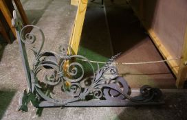 A large wrought iron coaching inn or shop swing sign bracket, early 20th century, with scrolled