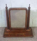 A Victorian mahogany dressing table swing mirror, with plain turned supports and a platform base,