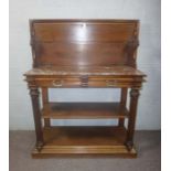 An unusual Victorian mahogany buffet, circa 1880, the moulded hinged top lifting to reveal a Rosso