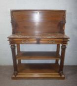 An unusual Victorian mahogany buffet, circa 1880, the moulded hinged top lifting to reveal a Rosso
