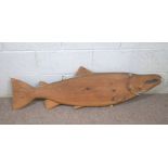 A vintage pine model of an Atlantic Salmon, 125cm long; together with an Egyptian camel saddle, 20th