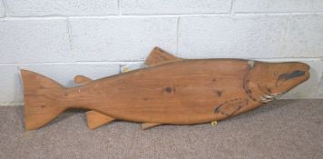 A vintage pine model of an Atlantic Salmon, 125cm long; together with an Egyptian camel saddle, 20th