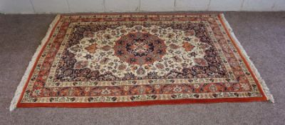 A large modern Turkish rug, with eight geometric octagons on a dark red ground, 260cm x 200cm