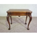 A George II style mahogany concertina tea table, 20th century reproduction, with foldover top, on