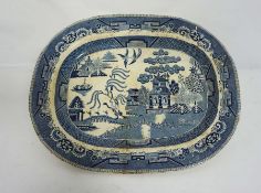 A very large blue and white ‘Willow Pattern’ meat ashet or platter, stamped ‘Best Goode’, 54cm wide;