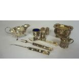 A small group of silver, including a Mappin & Webb sauceboat, 15cm wide; Four silver condiments ,