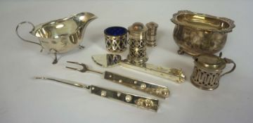 A small group of silver, including a Mappin & Webb sauceboat, 15cm wide; Four silver condiments ,