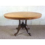 A Victorian walnut and inlaid loo table, circa 1860, the oval tilt top inlaid with a decorative